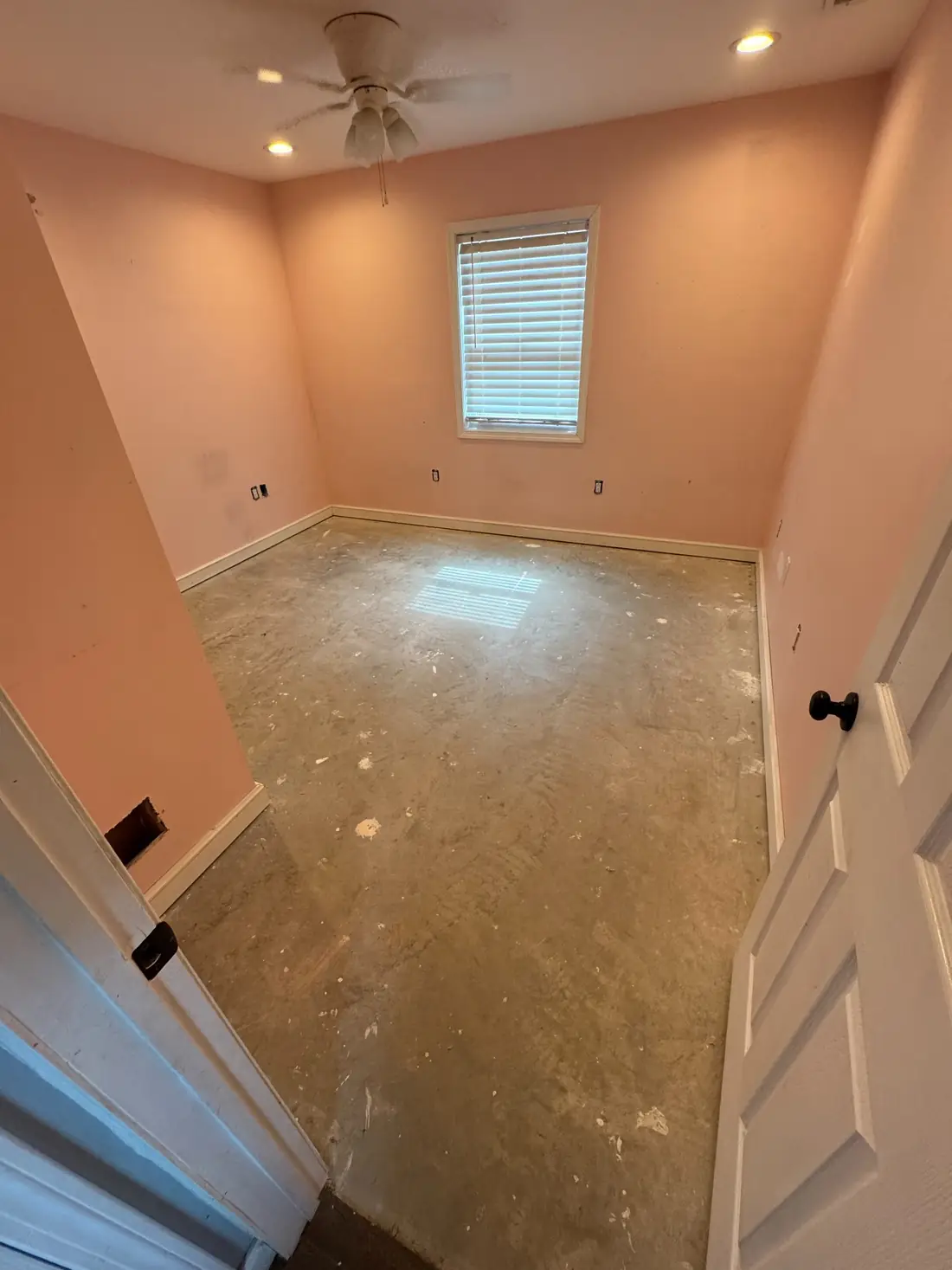 Bedroom with the original pink wall color before painting