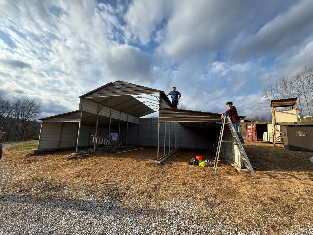 Crew assembling the steel frame and exterior panels over the new support work