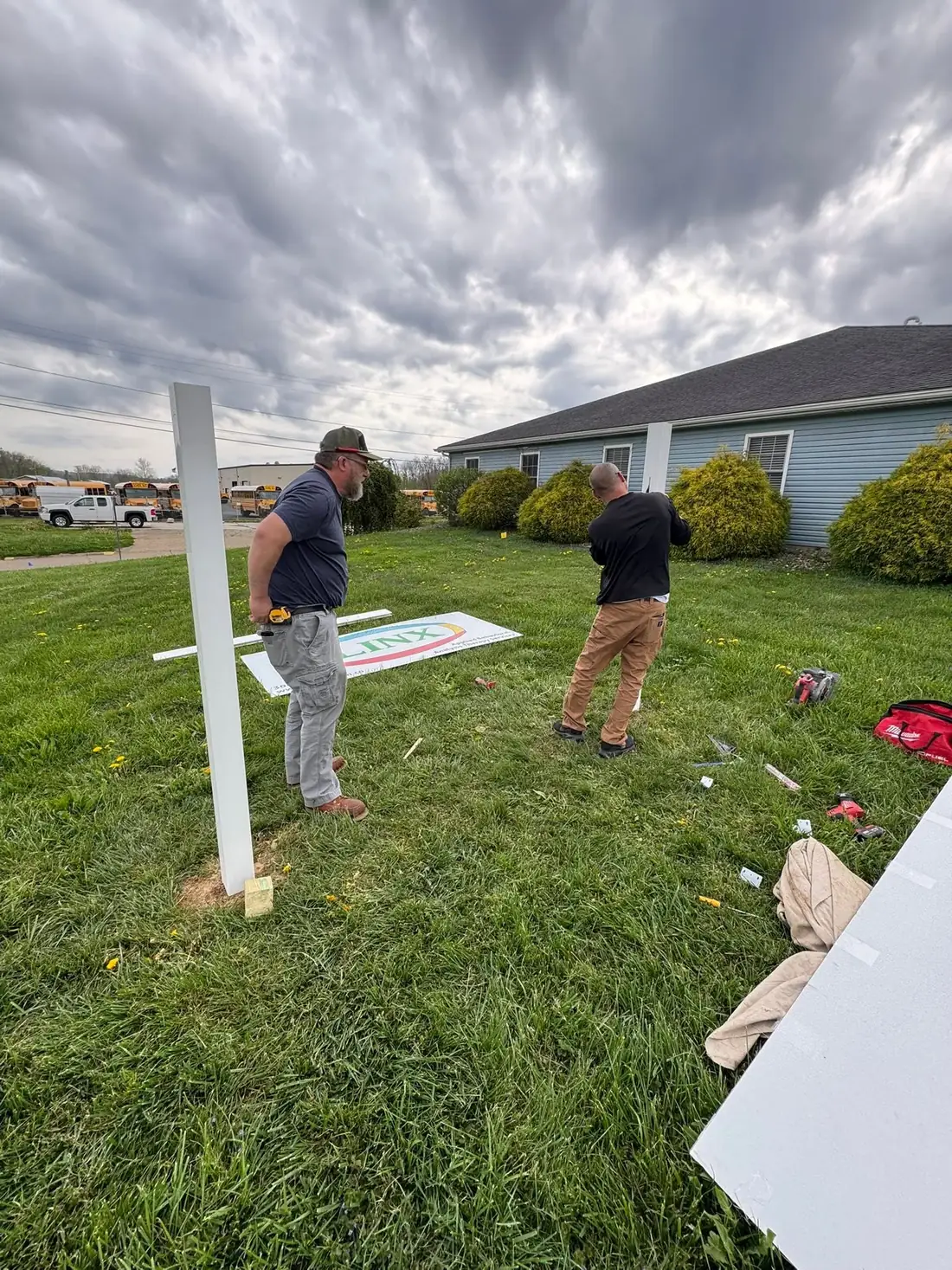 Frontline crew assembling the commercial sign panel and frame in the field