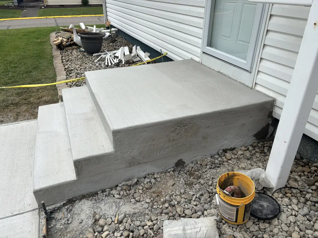 Side view showing the formed concrete landing, steps, and finished edges
